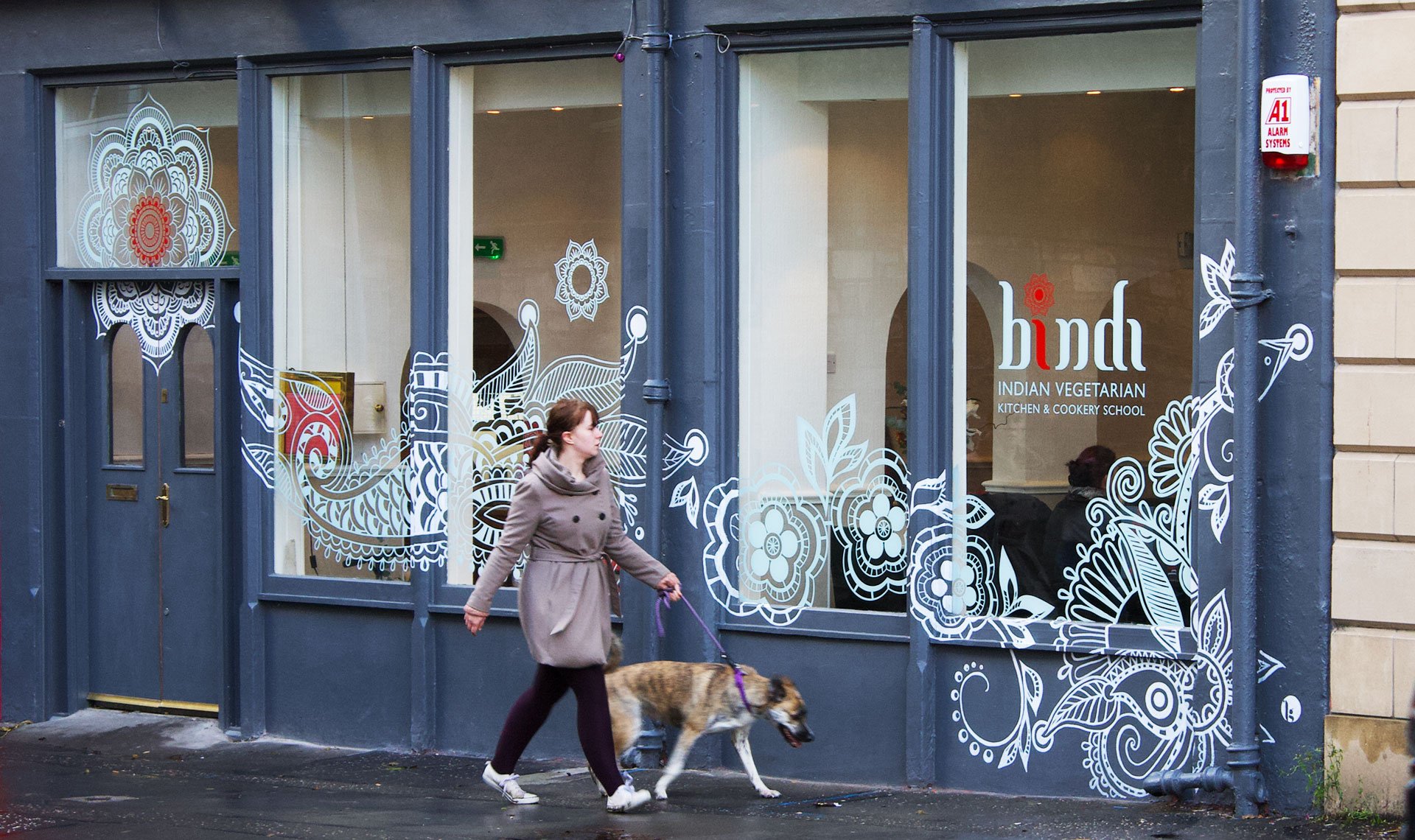 Bindi based on henna art painted on wall exterior of restaurant and window